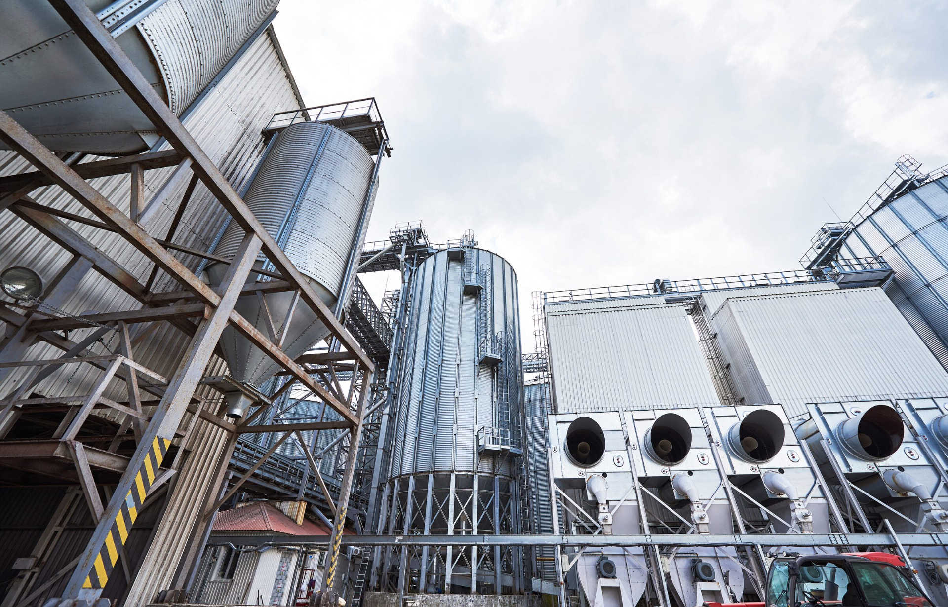 Industrial storage silos against an overcast sky