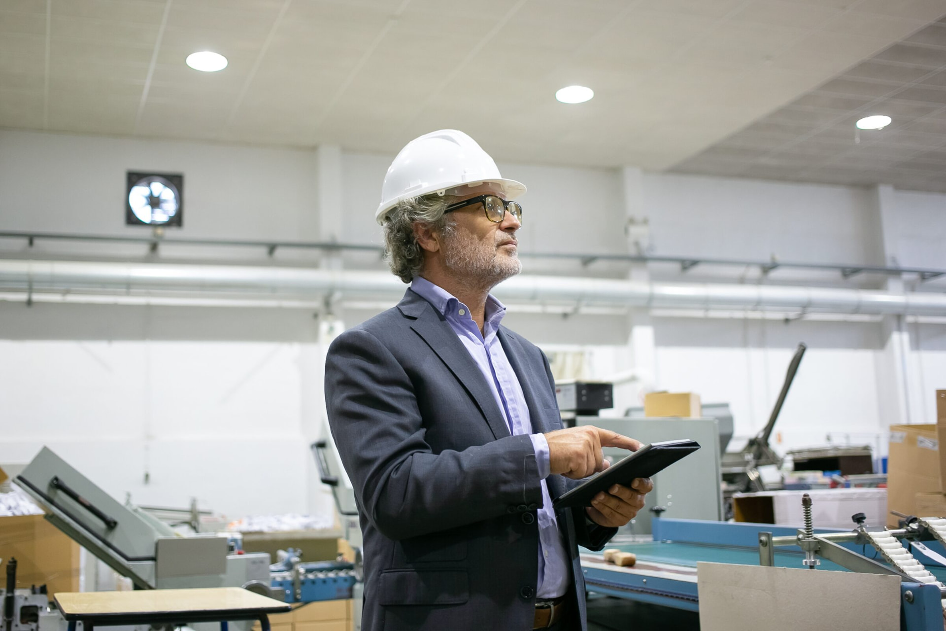 Business owner reviewing production on the floor of a print works