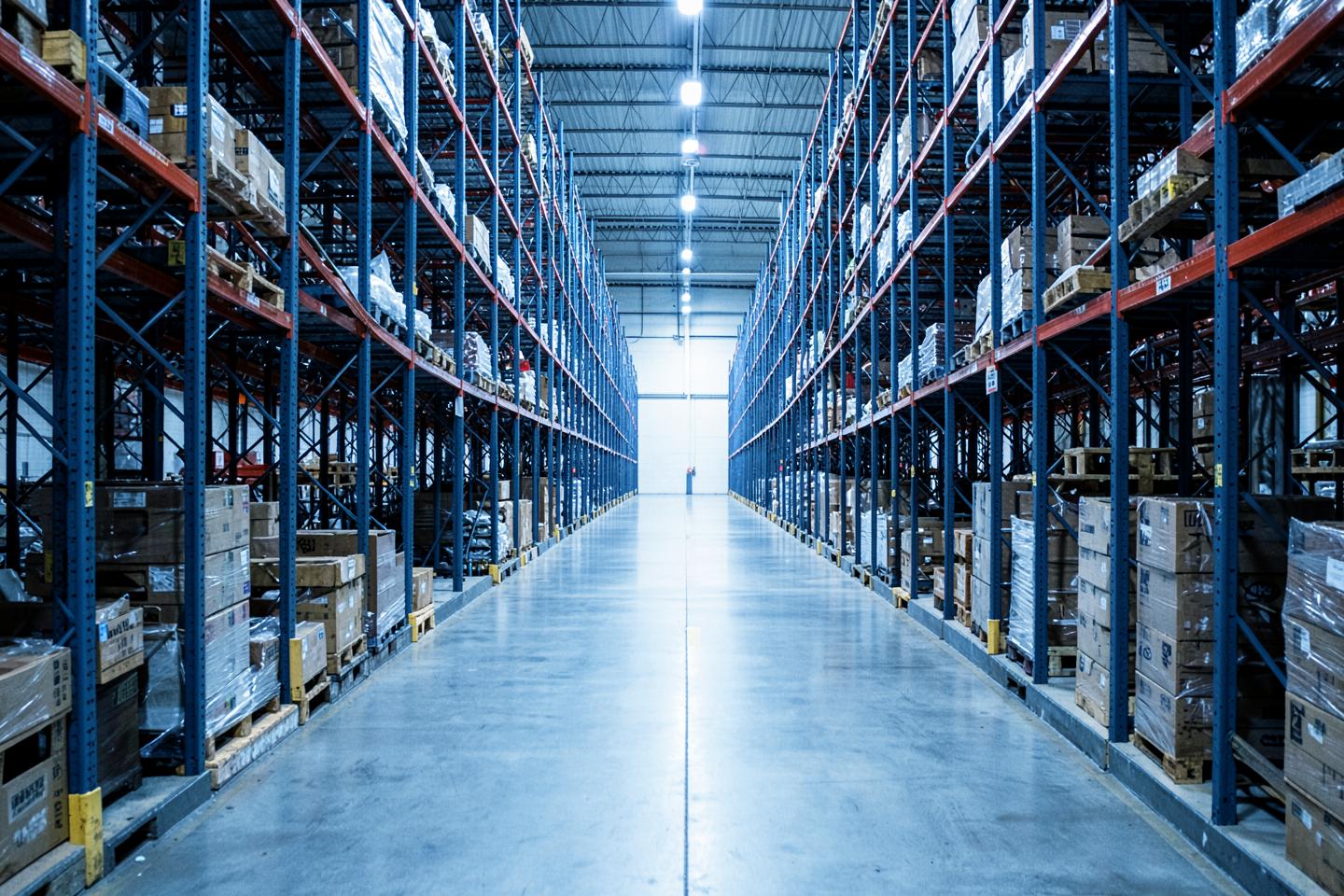 Long aisle between tall pallet racks in a distribution warehouse